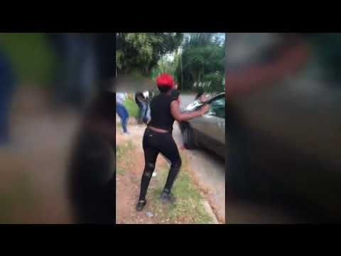 SUV runs through women involved in street brawl